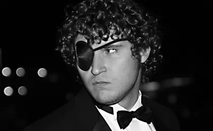 man wearing a tuxedo and eye patch